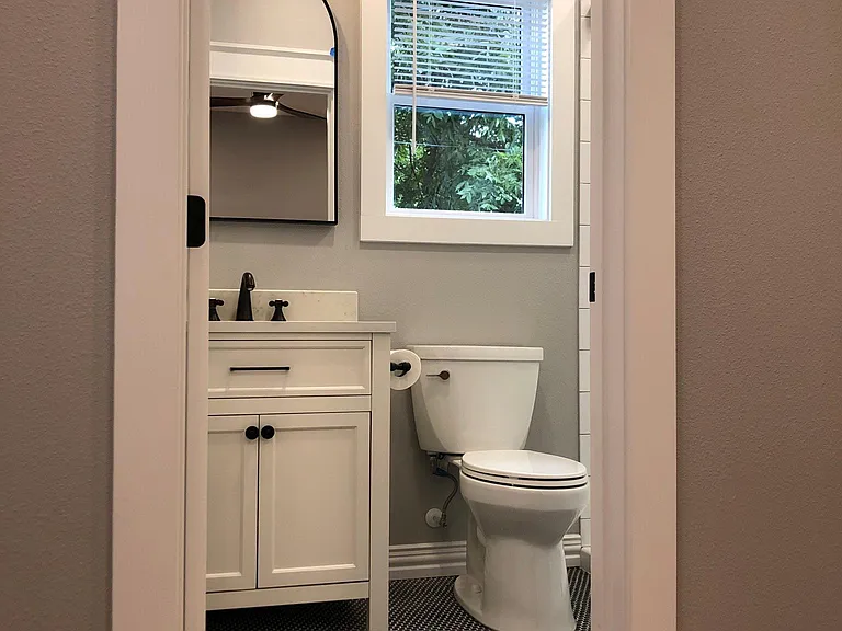 private bathroom with pendant and can lighting, tile flooring throughout