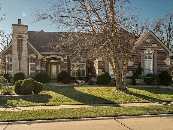 The seating bench to the right of the Main Entry overlooks a small pond and fountain water feature with lighting.