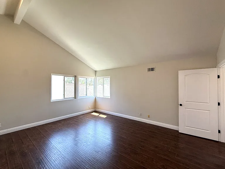 Primary bedroom viewed from bathroom entrance