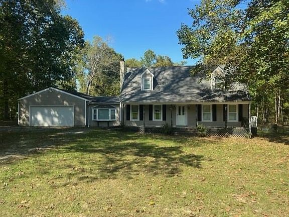 Front of house with country front porch and 2-car garage