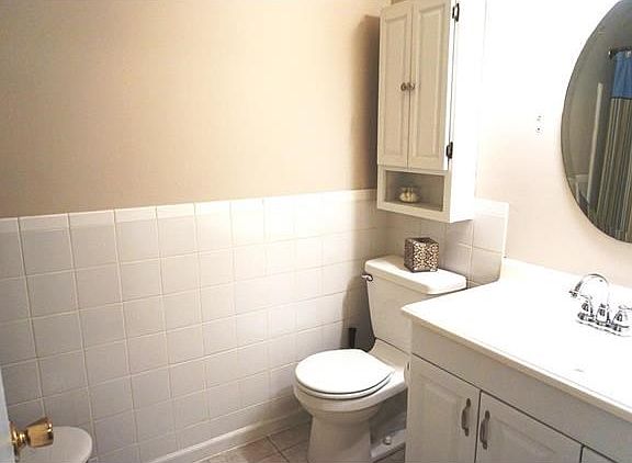 Bath has updated tile and cabinets.