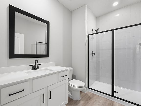 The master bathroom has a spacious vanity and a walk-in shower
