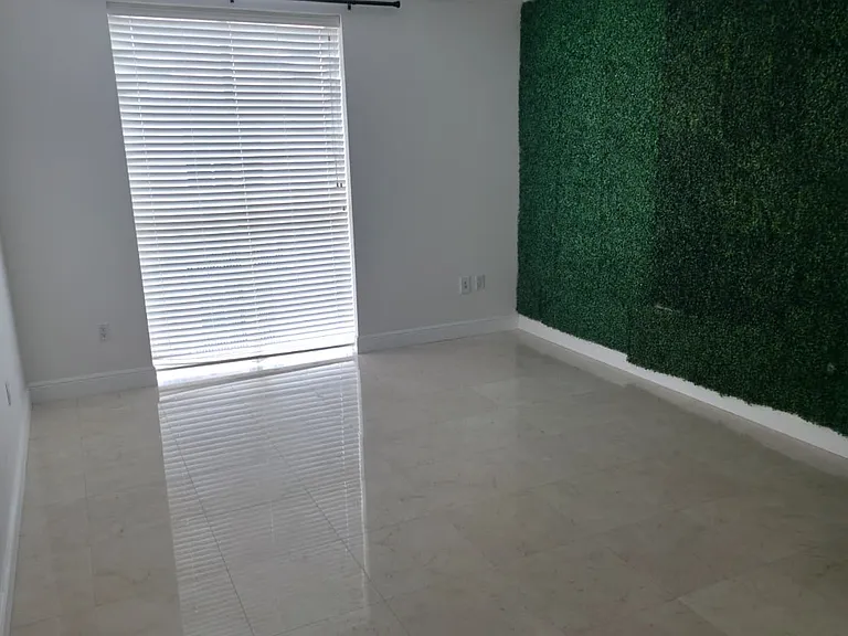 Large Master bedroom with large floor to ceiling window. Second floor