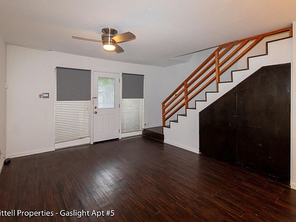 View of the front door entrance and living area. The large windows in the front allow for plenty of natural light.