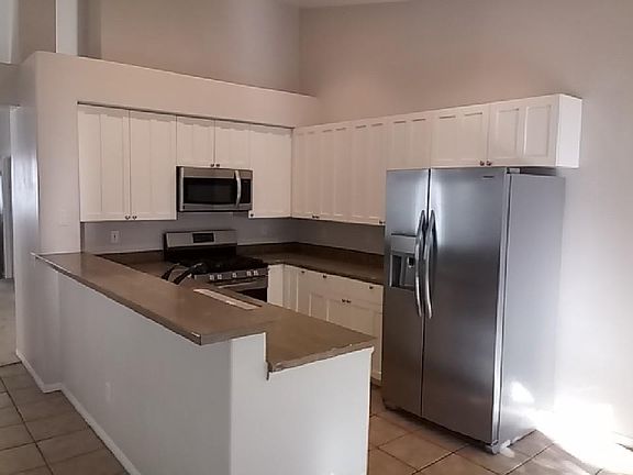 Kitchen with brand new refrigerator