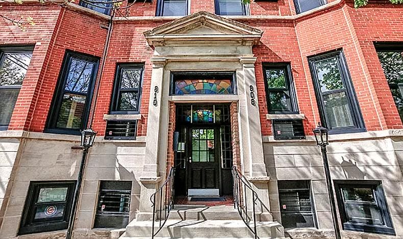 Stained glass front entry with gas burning lanterns