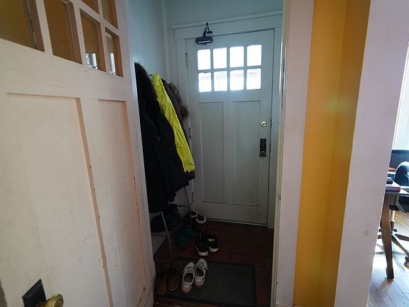 Front entry way from the porch. Living Room is in Red to the left and front Bedroom (painted green) is to the left.