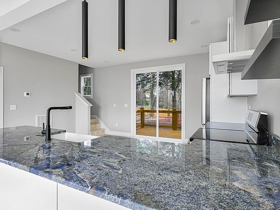 Custom granite with gold hue woven in a blue palette.