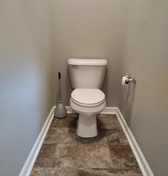 The toilet is located in an enclosed area inside the bathroom.