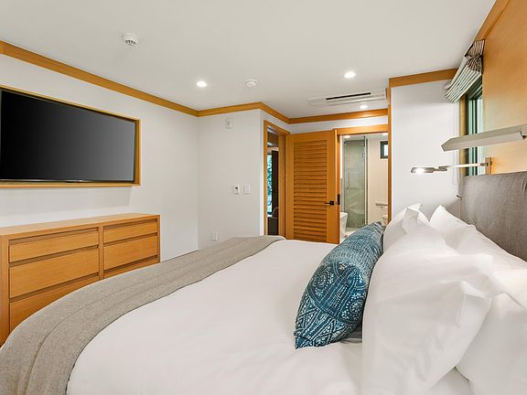 King sized bed fully outfitted with high quality linens and down comforter for a dreamy sleep.