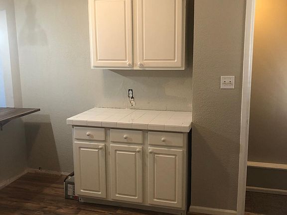 More kitchen cabinets and hall to the basement and back patio.