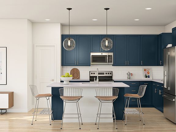 Kitchen with pendant lighting and blue cabinets