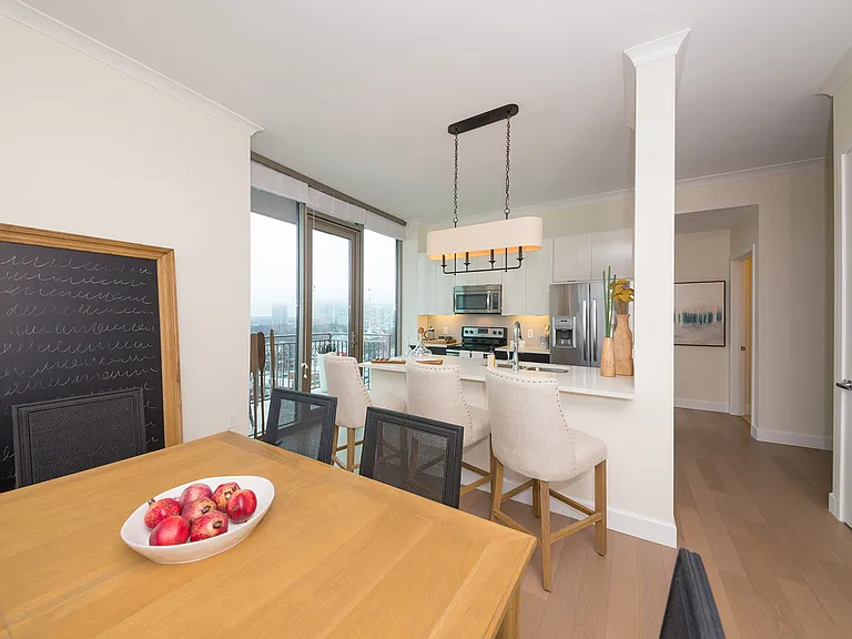 Floor-to-ceiling windows bring in abundant daylight and frame skyline views from this bright dining setting