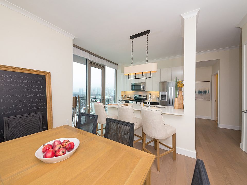 Floor-to-ceiling windows bring in abundant daylight and frame skyline views from this bright dining setting
