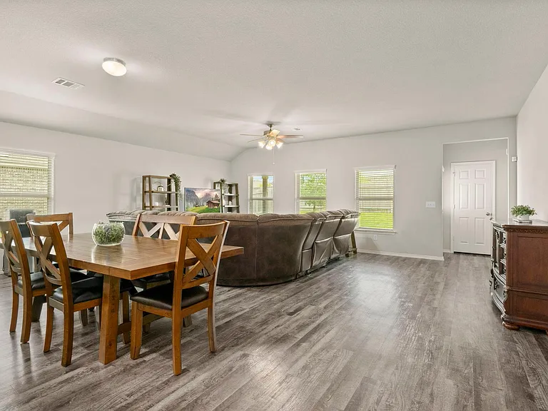 OPEN FLOOR PLAN FLOWS INTO GENEROUSLY SIZED LIVING AREA FILLED WITH WINDOWS