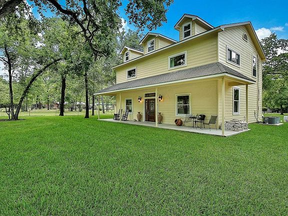Large mature trees add shade to the front of this charming home.