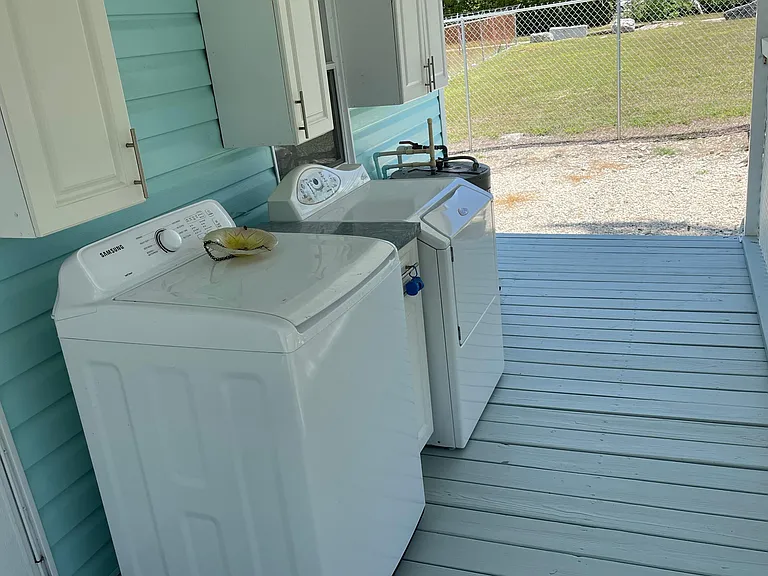 Covered laundry room with washer and dryer
