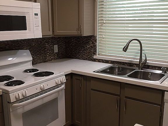 Kitchen looks out to covered