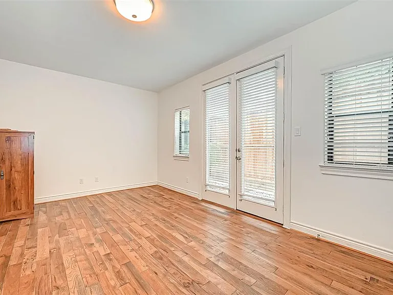 1st floor bedroom with hardwood floor and natural light