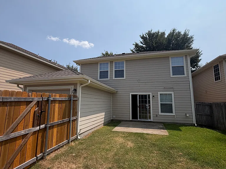 Back of house, dual car tandem garage on the left