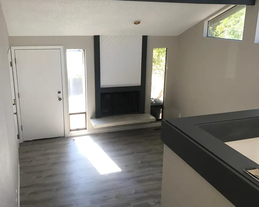 Spacious living room with fire place and vaulted ceilings wi