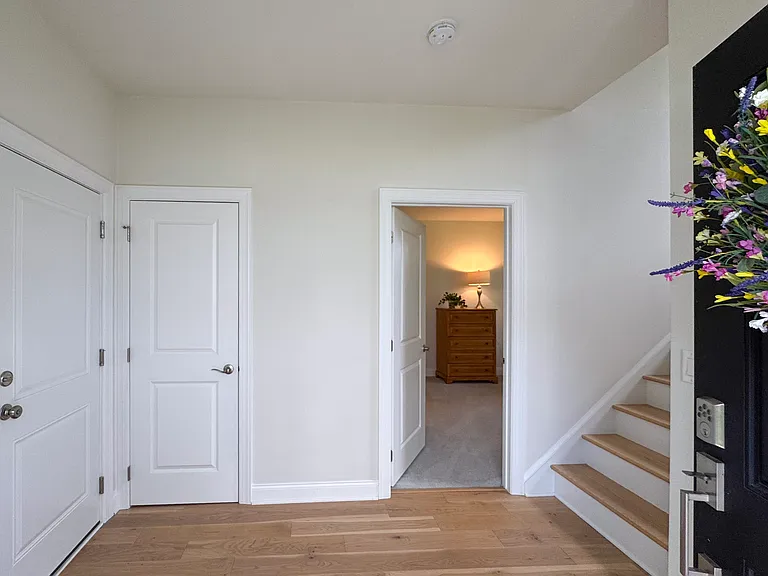 The first floor offers an entrance foyer, a 4th bedroom/guest suite or office space, access to the 2 car garage and 2 coat closets.