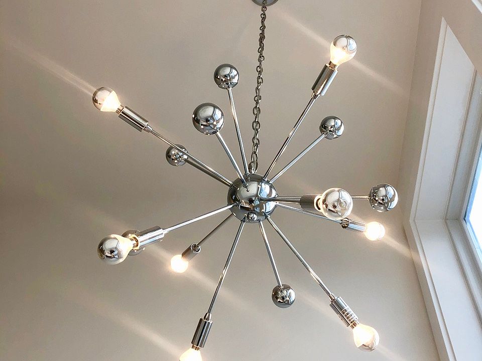 The twin upstairs units each have unique light fixtures, highlighted by the cathedral windows