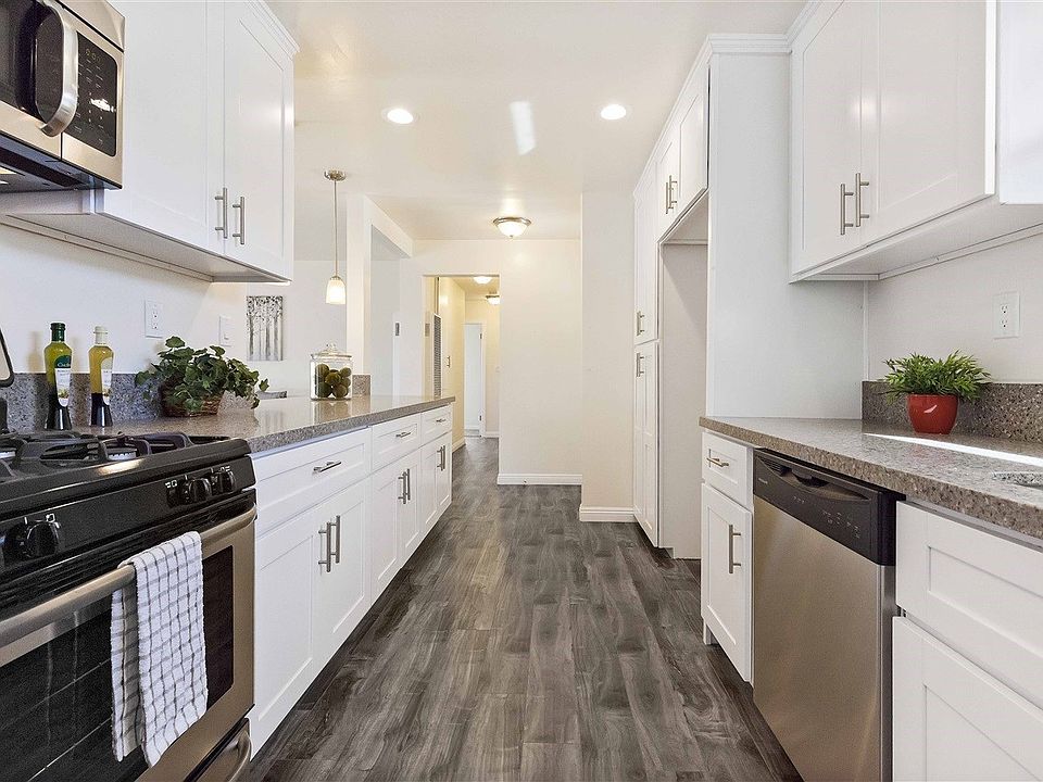 New custom kitchen with beautiful quartz counter tops, new floors & stainless steel appliances.