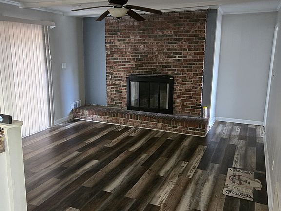 Den with wood fireplace