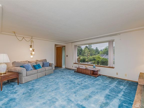 Huge living space, large window lets in lots of light! Hardwoods under carpet.
