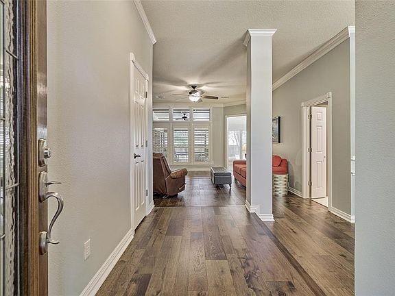 As you enter the home you are greeted with beautiful wood floors, high ceilings and updated custom paint!