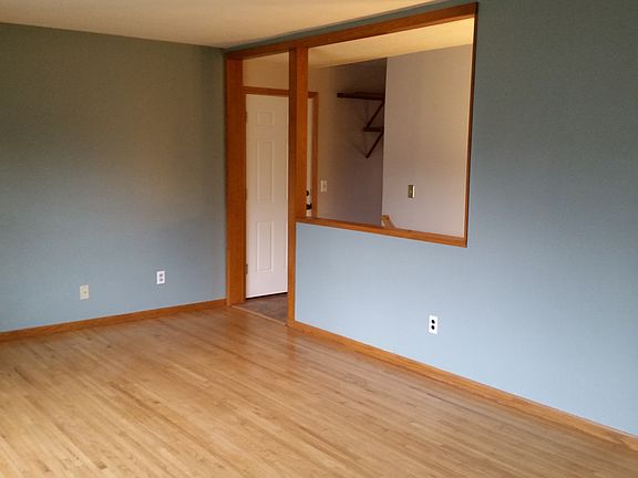 Living Room with huge picture window and hardwood floors. Op