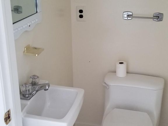 Small powder room first floor (between kitchen and dining room)