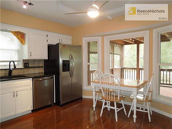 Updated kitchen with eating area overlooking screened in porch and backyard.