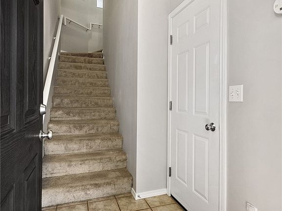Tile Entryway - Door to the right goes to your private garage. The stairway goes to living space.