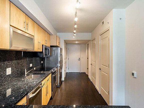 To the left of the front door is the HVAC and hall closet. To the right of the door is the large bathroom, another hall closet, and the washer/dryer.