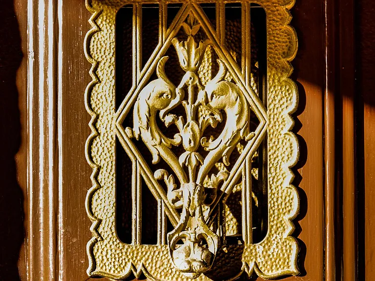Ornate front door welcomes guests upon arrival.