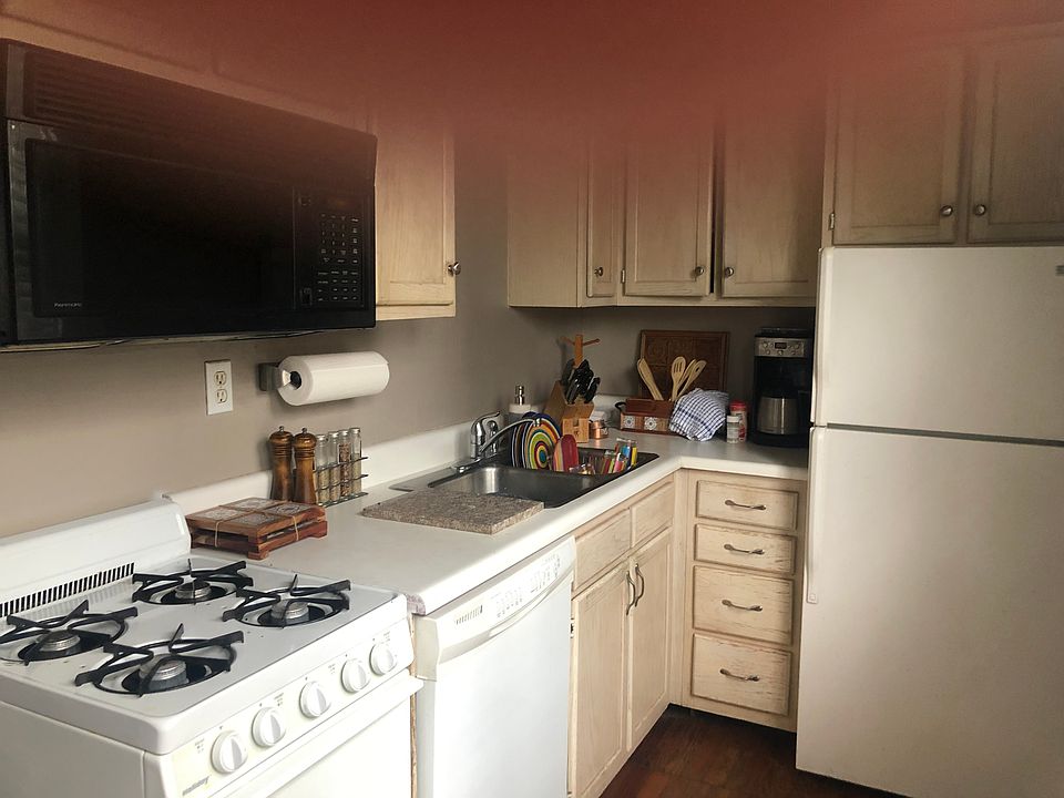 Compact full kitchen includes stove, dishwasher, refrigerator, microwave