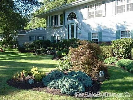Front of home
						:
						Mature plantings watered by private well.