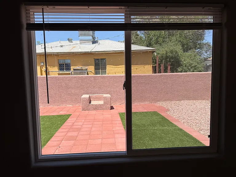 View of private outdoor area with paver patio and turf accents