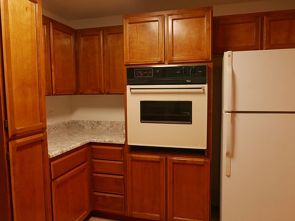 Plenty of storage in this compact kitchen with a retro wall oven and refrigerator.