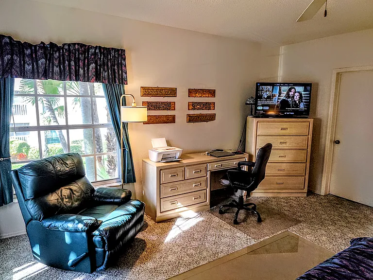 Master bedroom with an office corner