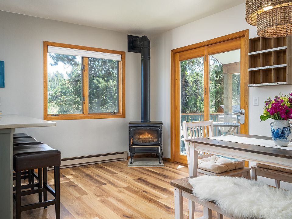 Dining area with gas stove that keeps the home nice and warm. Nice view out the back and side. This home has rare open space that can be view right out of the unit.