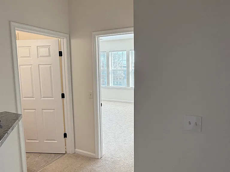 Hallway leading to secondary bedroom/bathroom