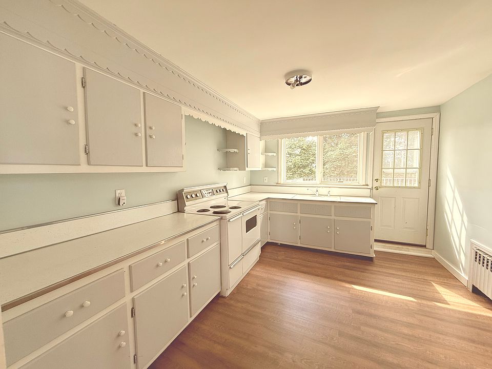 Large vintage eat-in kitchen with ample counter space. The door on the right opens up to private second floor balcony.