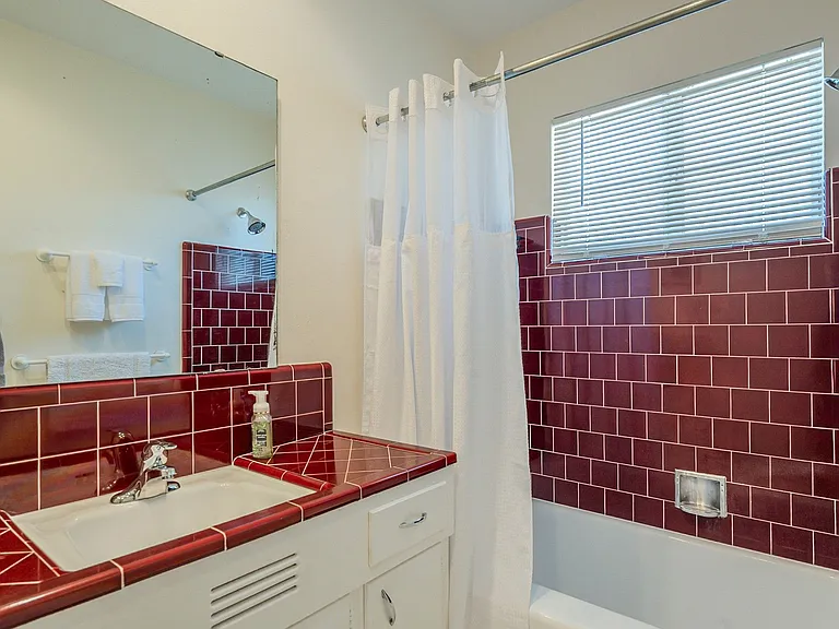 Original subway tile in perfect condition with newly resurfaced bathtub.