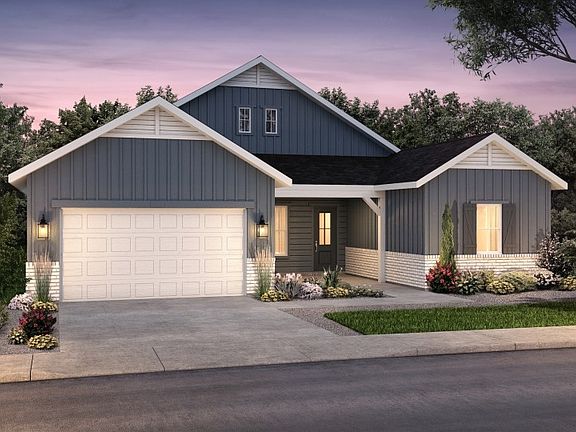 The classic Farmhouse elevation boasts stylish brick accents and window shutters for added curb appe