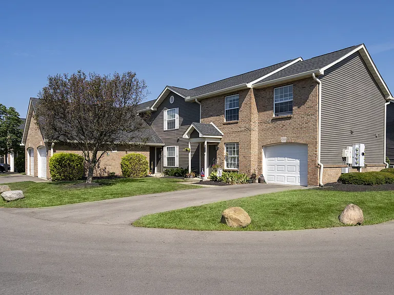 Step up to a home with timeless curb appeal, featuring a clean design and a welcoming driveway.