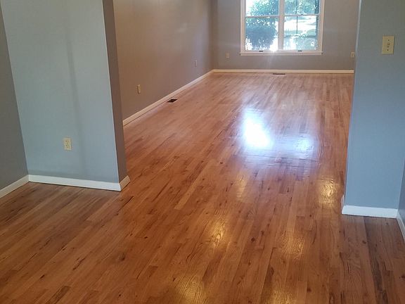 Large Living Room on Level 1 with plenty of sunlight through large window, recessed lights & beautiful finished wooden floor