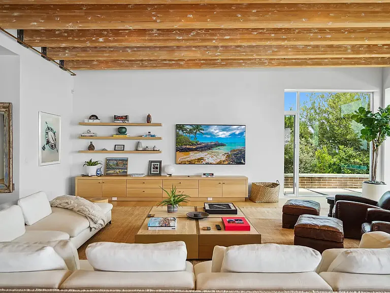 The spacious living room features custom designer furniture and 13' ceilings.